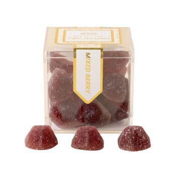 TribeTokes CBD Wellness Mixed Berry gummies in a clear cube box with three sugar-coated berry gummies in front on a white background