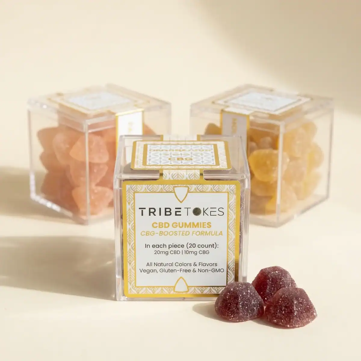 Three flavors of TribeTokes CBD Wellness gummies lined up, with the Mixed Berry box in front showing the CBG-boosted formula, 20mg CBD and 10mg CBG per piece, and two other varieties behind