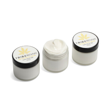 Three jars of TribeTokes TribeRevive CBD Pain Relief Cream on a white background, the center jar open to show the whipped cream, each labeled 1,000 mg of CBD and 2.0 oz