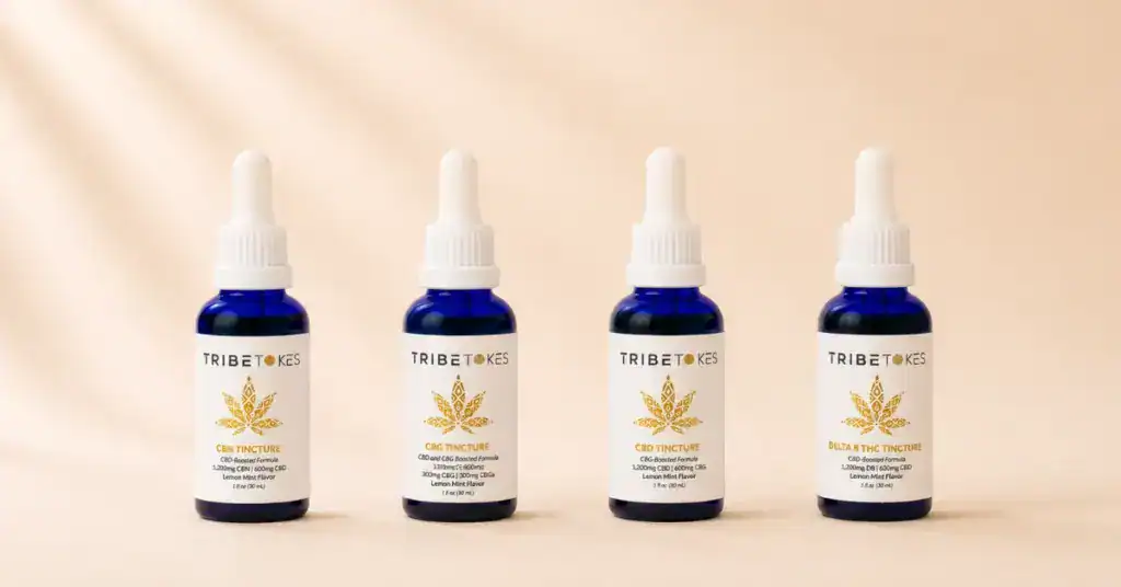 TribeTokes CBD CBG CBN and Delta-8 cannabis tincture bottles lined up on a cream background representing the complete guide to cannabis tinctures sublingual dosing and effects