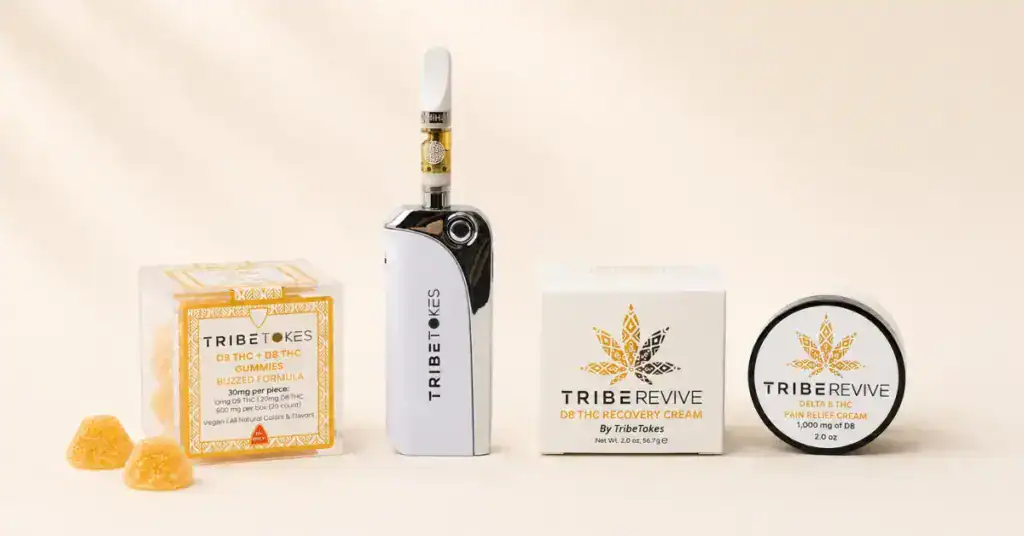 Product line up of TribeRevive Delta-8 pain cream alongside gummies and a vape cartridge on a cream surface representing the comparison of topicals edibles and vapes for pain relief