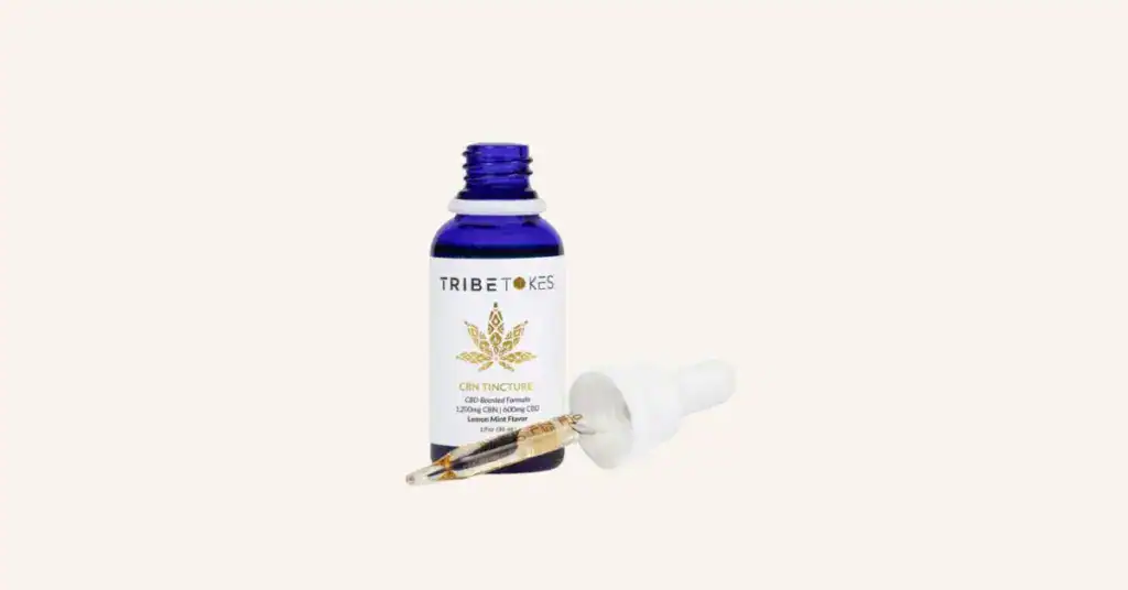 TribeTokes CBN sleep gummies and CBN tincture on cream background, representing a complete guide to cannabinol