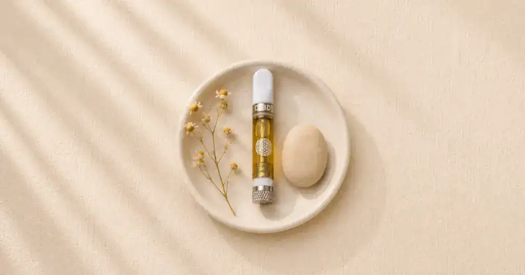 TribeTokes 1:1 CBD Delta-8 vape cart on cream background with soft botanicals — approachable flatlay for first-time cannabis user guide on dosing, setting and what to expect