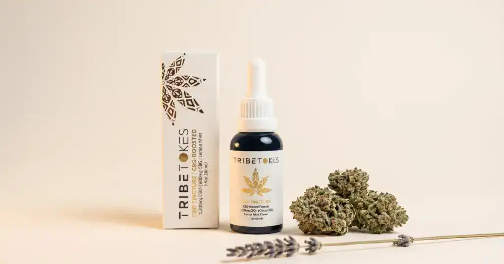 TribeTokes CBG-Boosted CBD Tincture beside cannabis flower buds and a lavender sprig on a cream surface, representing the lab-tested cannabinoid and terpene profile found on a cannabis Certificate of Analysis