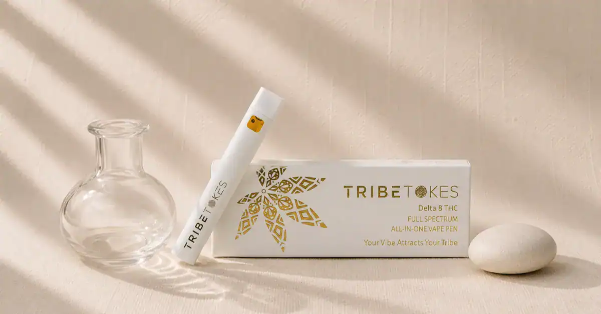 TribeTokes vape cartridge with clear glass vessel on cream linen — editorial flatlay representing residual solvent testing, extraction purity and hemp safety standards explained