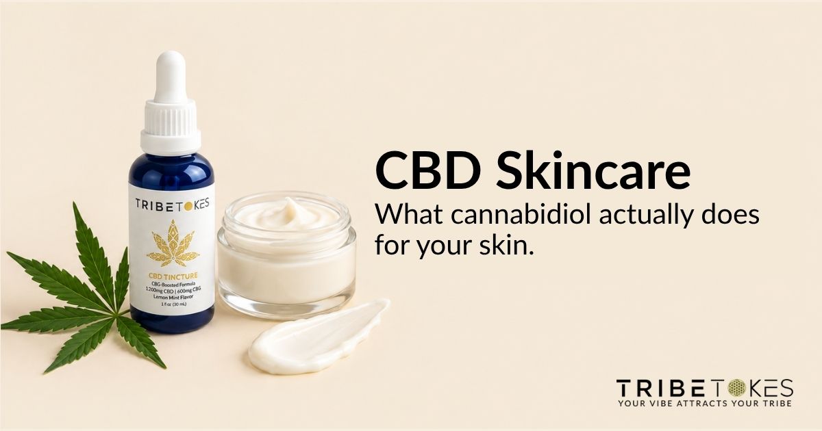 Dropper bottle of CBD tincture oil beside a hemp leaf and skincare